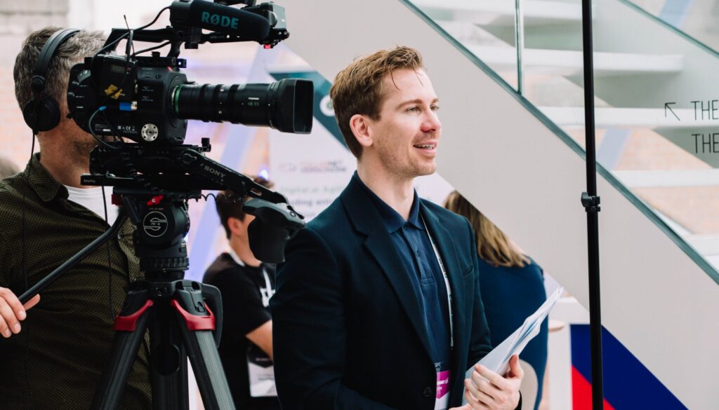 Professional videographer filming live event with LUPU Agency equipment.