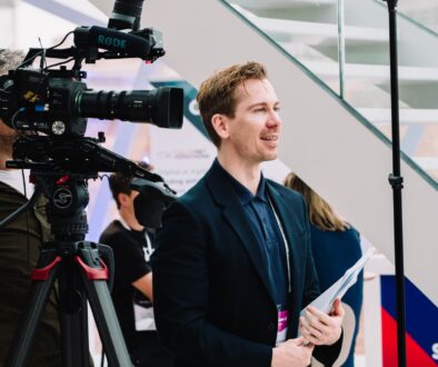 Professional videographer filming live event with LUPU Agency equipment.
