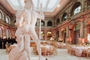 Elegant gala dinner surrounded by classical marble sculptures at Museo del Prado, Madrid