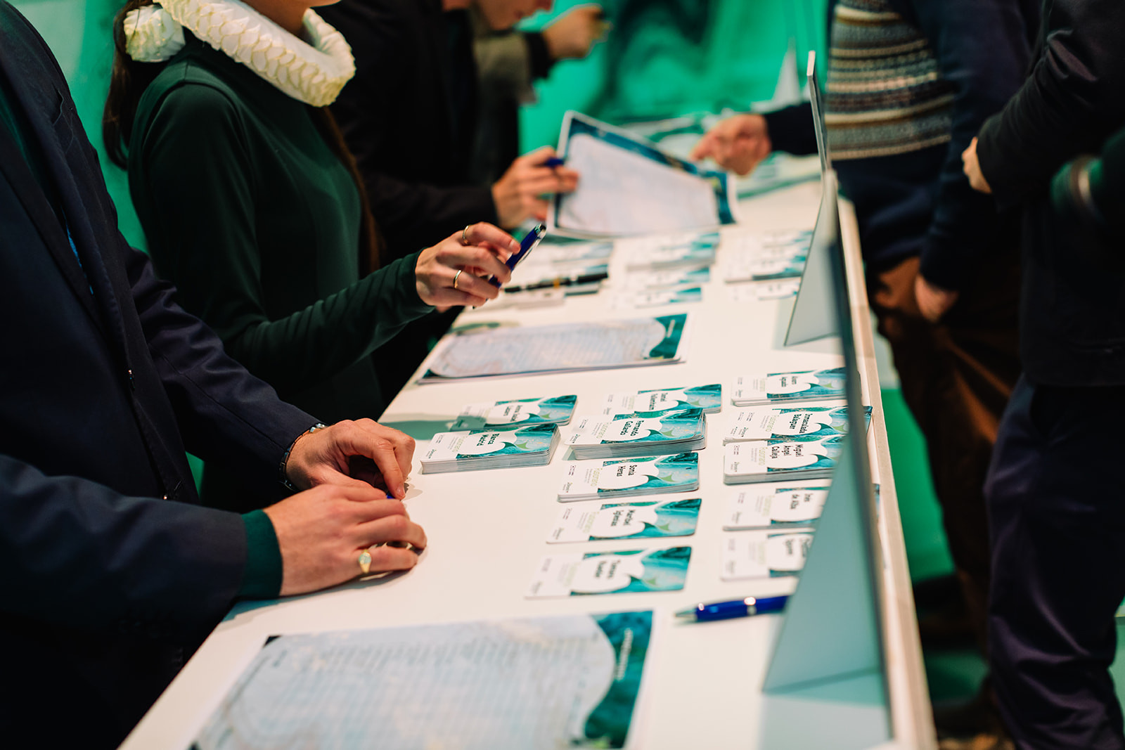 Attendees collecting materials at the registration desk of a conference in Madrid