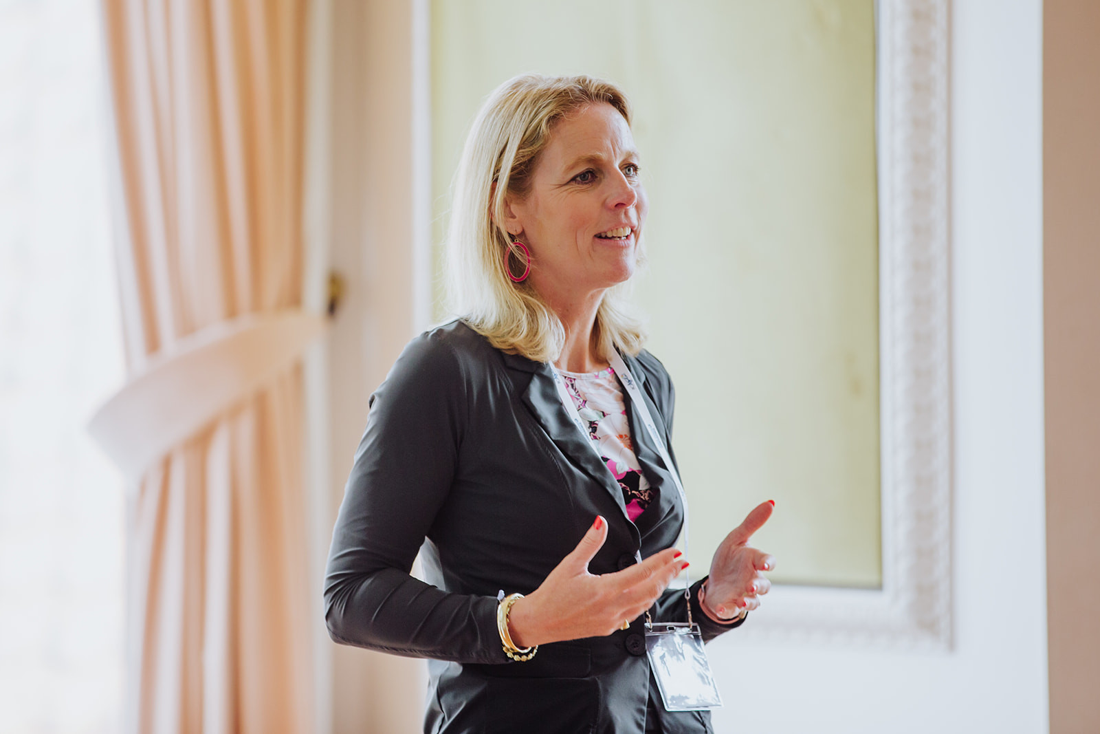 Speaker presenting in a room lit by daylight from a large window