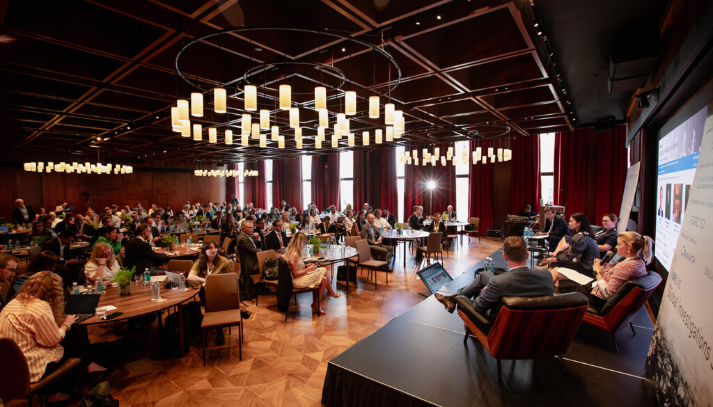 Sustainable event photography: conference hall in Madrid with guests at tables and a stage