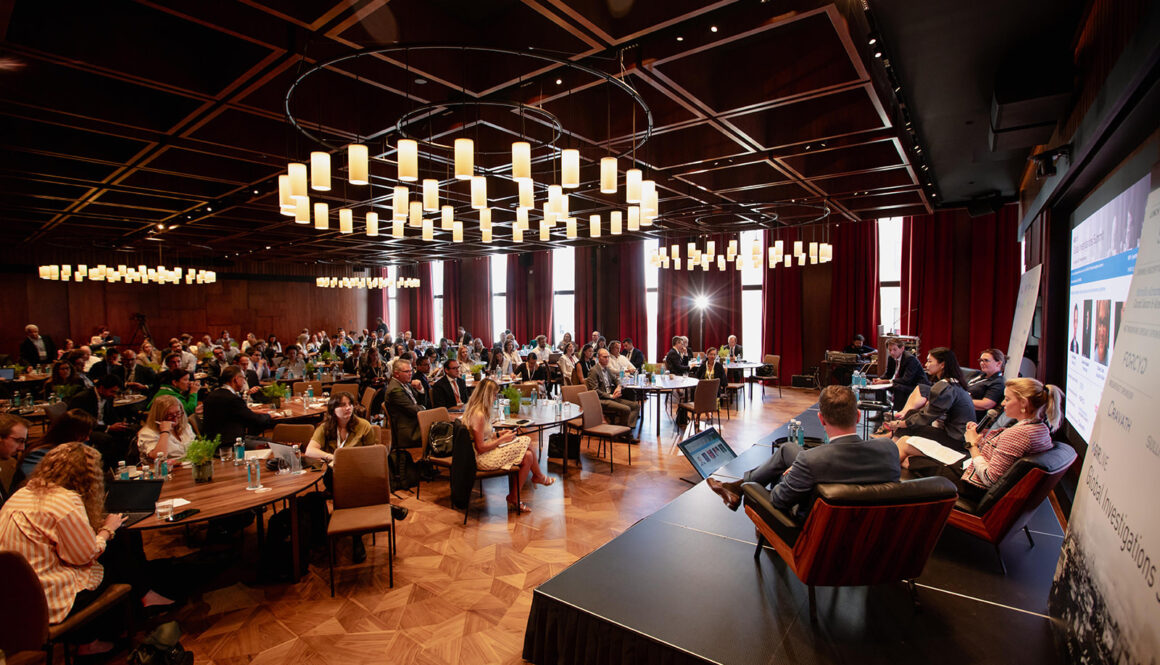 Sustainable event photography: conference hall in Madrid with guests at tables and a stage