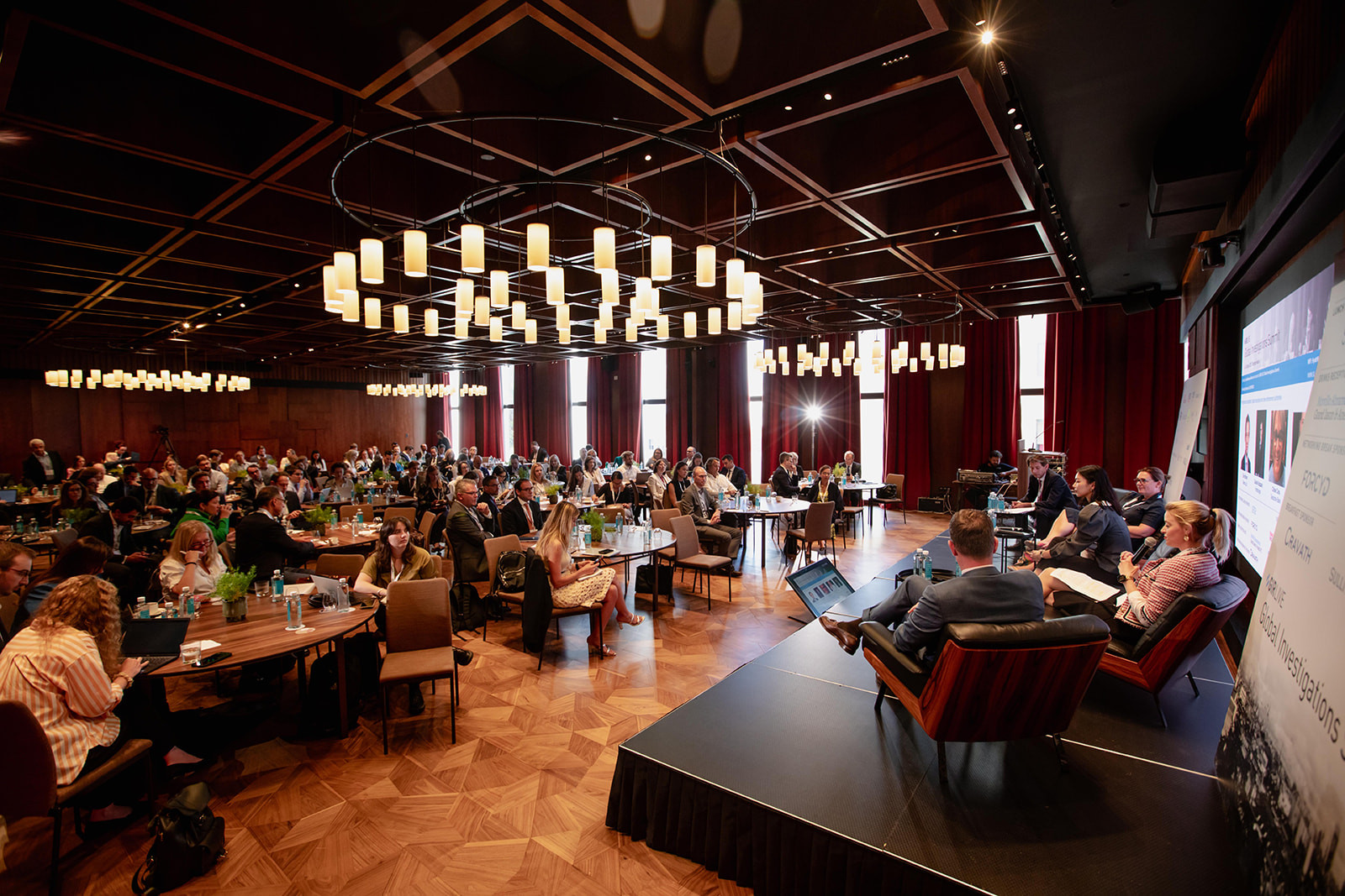Sustainable event photography: conference hall in Madrid with guests at tables and a stage